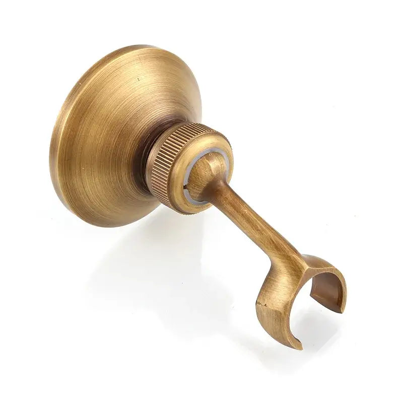 Antique brass handheld shower holder with adjustable curved hook and circular wall-mounted brass base by decorbites