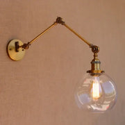 Decorbites antique brass swing arm wall lamp with adjustable brass sconce and clear glass globe housing exposed bulb
