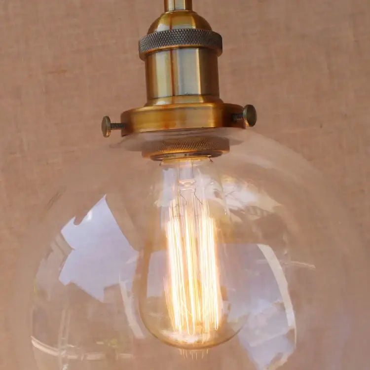 DecorBites antique brass wall lamp swing arm with warm-toned vintage pendant light and clear glass filament bulb
