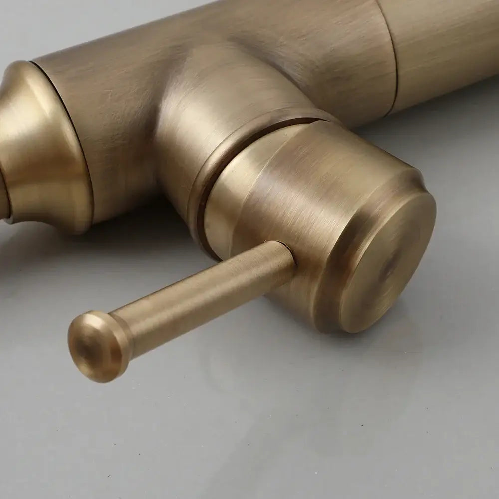 DecorBites antique brass oil rubbed bathroom faucet with single handle and cylindrical spout in brushed metal finish