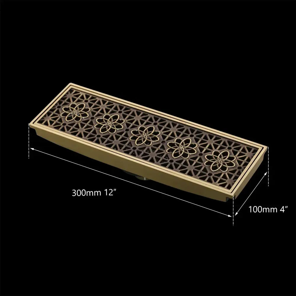 DecorBites™ antique brass rectangular floor drain strainer with intricate floral and geometric cutout patterns for deodorization