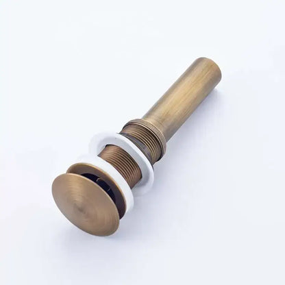 Antique brass round siphon pop-up drain with white ceramic flange and threaded metal body for bathroom vanity basin