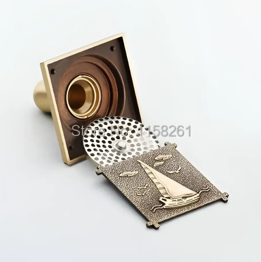 Decorbites antique brass shower drain cover with brass sailboat and clouds design for bathroom use