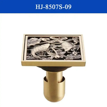 DecorBites antique brass shower drain cover with intricate silver-toned fish and lotus flower relief design