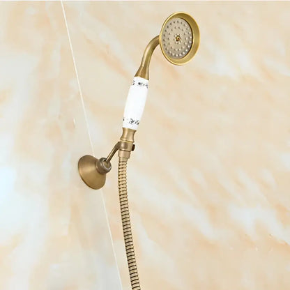 DecorBites™ antique brass shower faucet set with brass handheld showerhead, white ceramic floral handle, and flexible metal hose
