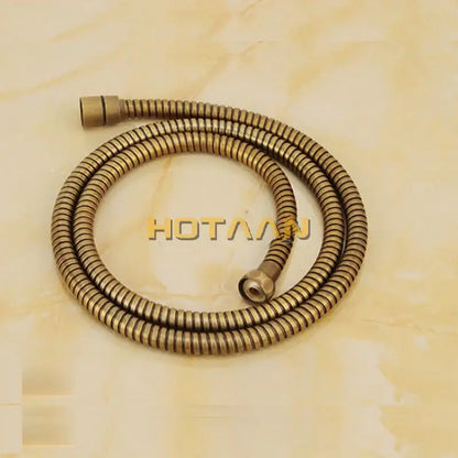 Brass-colored flexible shower hose with coiled design and metallic connectors in DecorBites antique brass shower faucet set