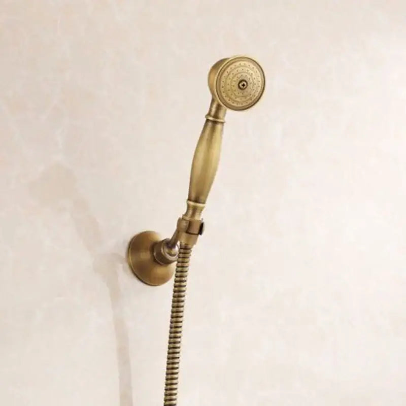 Decorbites™ antique brass shower set featuring an antique brass shower head with classic elongated handle and textured nozzle
