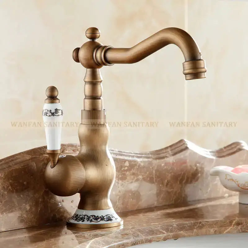 DecorBites™ antique brass single handle basin faucet with white ceramic handle and black floral patterned base