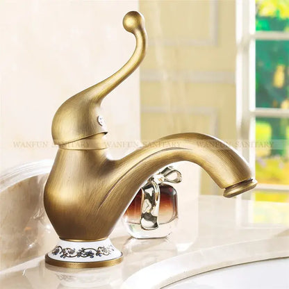Decorbites™ antique brass single handle deck mount bathroom sink faucet with elegant curved spout and ornate base