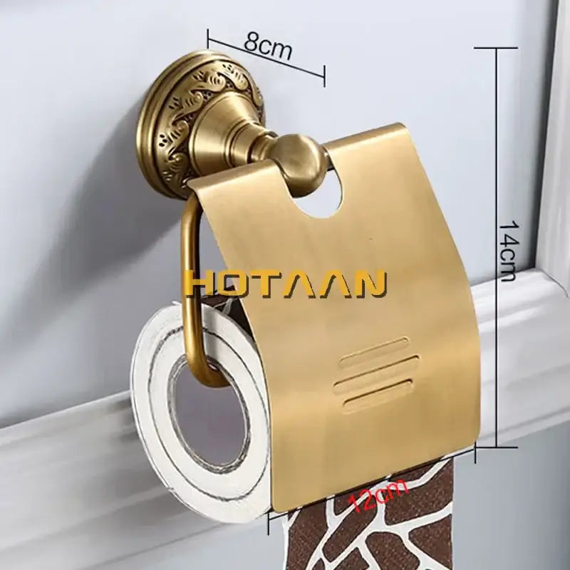 Gold-colored brass toilet paper holder with ornate wall mount and sleek minimalist design for vintage bathroom use