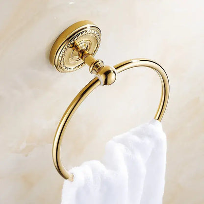 Gold-toned brass antique brass towel ring with ornate decorative mounting plate and polished finish for bathroom use