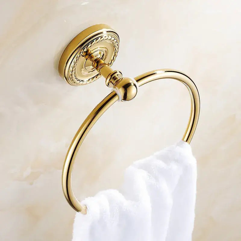 Gold-toned brass antique brass towel ring with ornate decorative mounting plate and polished finish for bathroom use