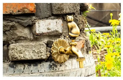 Decorbites antique brass wall mount garden faucet featuring a golden cat shape and sunflower design on brick wall