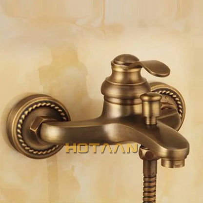 Decorbites antique brass wall mount shower head kit with antique brass faucet and ornate rope detailing on mounting plates