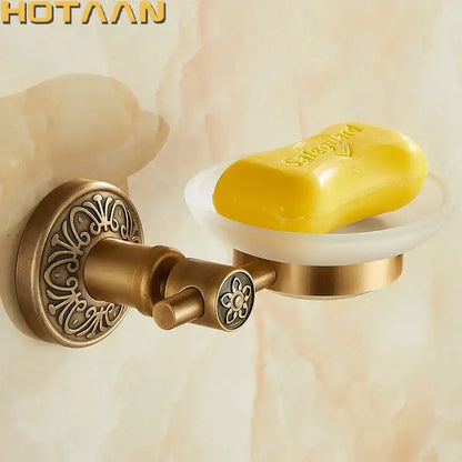 DecorBites™ antique brass wall mounted soap dish with ornate floral detailing and white ceramic bowl holding yellow soap