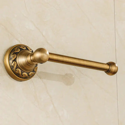 DecorBites™ antique brass toilet paper holder with ornate scrollwork and spherical end caps for vintage bathroom use