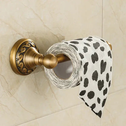 DecorBites™ antique brass toilet paper holder with ornate scrollwork holding white tissue paper with black heart leopard print