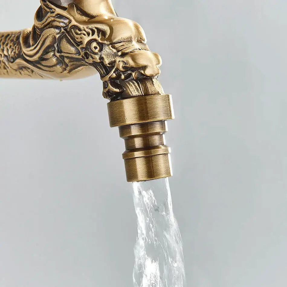 Antique brass wall mounted washing machine faucet with intricate dragon head design and flowing water for bathroom and garden
