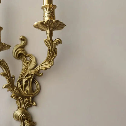 Golden ornate antique brass wall sconce with intricate leaf and scrollwork design from decorbites vintage lighting
