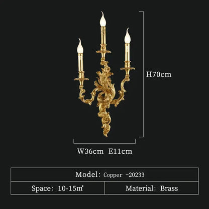 Gold-colored ornate antique brass wall sconce with three candle-style lights for vintage and rococo decor lighting