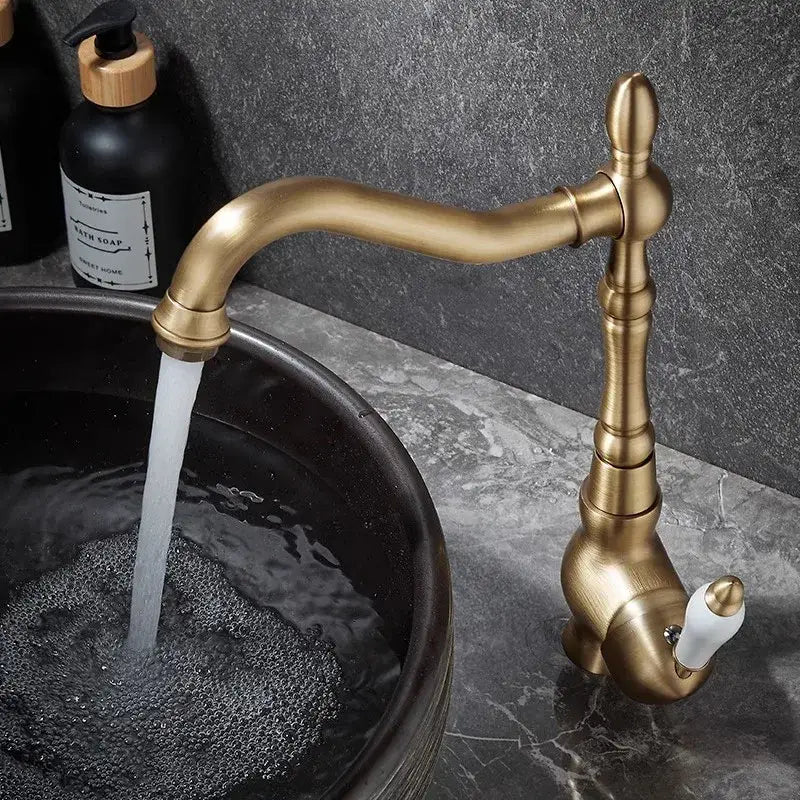 Decorbites antique bronze basin faucet with curved spout and ornate segmented brass body for kitchen or bathroom use