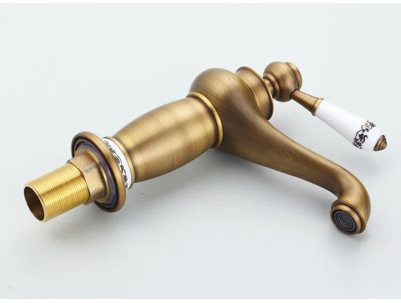 Decorbites antique bronze single handle bathroom faucet with white ceramic handle and black floral detailing real shot details
