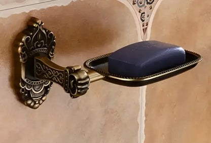 Antique bronze carved aluminum wall-mounted soap dish holding a dark blue bar of soap from decorbites bathroom set