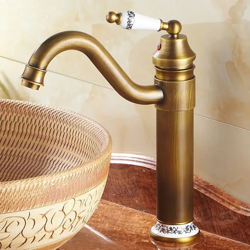DecorBites™ antique bronze finish single-handle bathroom faucet with white ceramic handle and black floral detailing