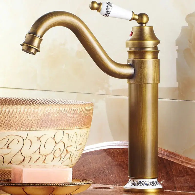 DecorBites antique bronze finish single-handle bathroom sink faucet with white ceramic handle and black floral detailing