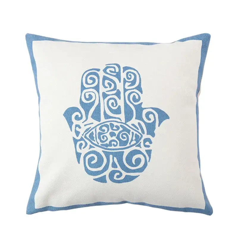 DecorBites™ pillow cover with white fabric base embroidered blue hamsa hand and antique brown tiger print tassels