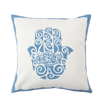 DecorBites™ pillow cover with white fabric base embroidered blue hamsa hand and antique brown tiger print tassels