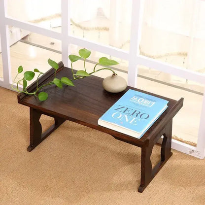 Dark brown solid wood foldable table with traditional carved legs and polished surface for hanfu shoots and tea cooking