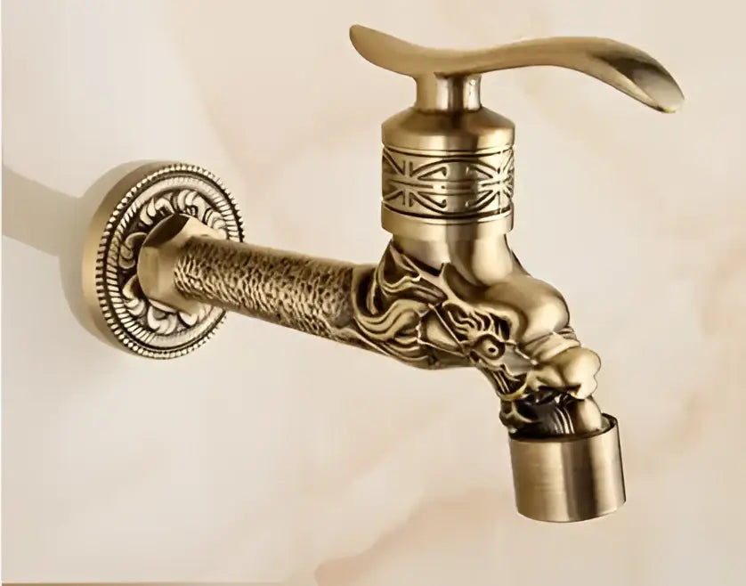 Antique brass decorbites garden bibcocks tap with ornate dragon head design and intricate engraved patterns for outdoor use