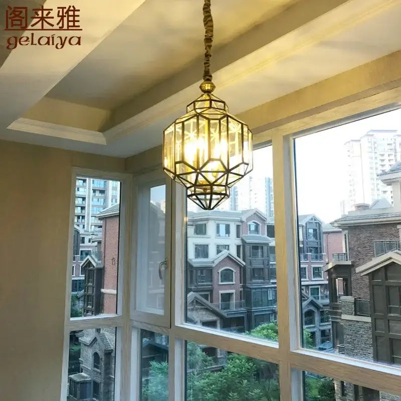 Brass-framed antique glass pendant light with clear panels and twisted cord suspension by DecorBites vintage style