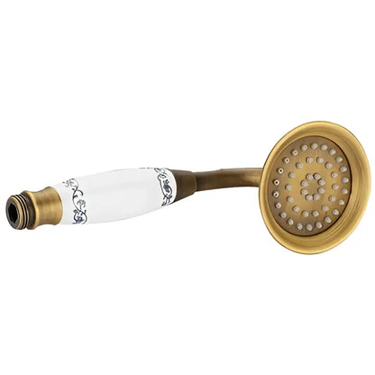 Decorbites antique handheld shower head in brass and white ceramic with ornate black pattern detailing and holder