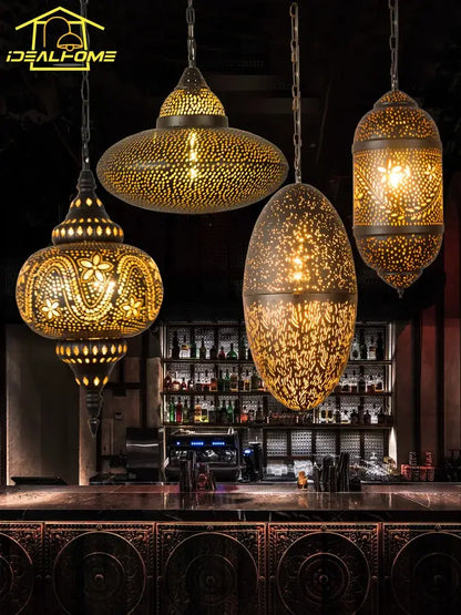Golden decorbites antique hollow carving pendant light with intricate cut-out designs hangs above a bar for vintage decor