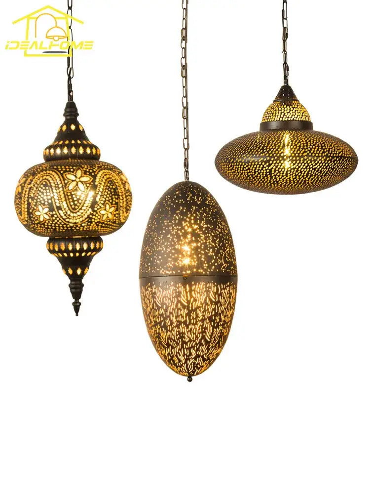 Three ornate brass DecorBites antique hollow carving pendant lights with intricate cut-out patterns and warm glowing light