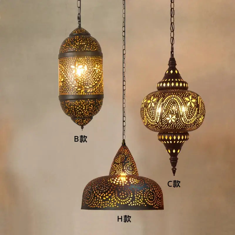 Three ornate brass decorbites antique hollow carving pendant lights with intricate floral and geometric patterns hanging