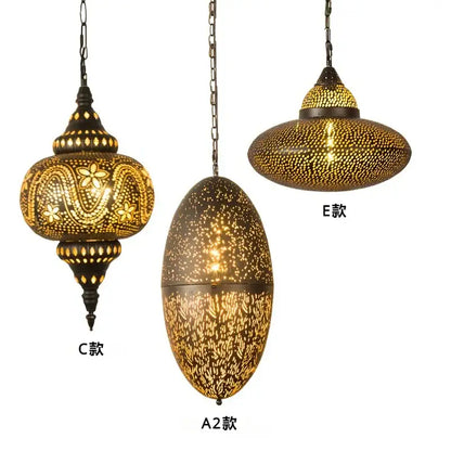 Three ornate brass decorbites antique hollow carving pendant light lamps with unique cut-out patterns hanging from chains