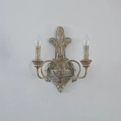 Antique iron double wall lamp by DecorBites with distressed finish and candle-shaped bulbs for retro bedroom use