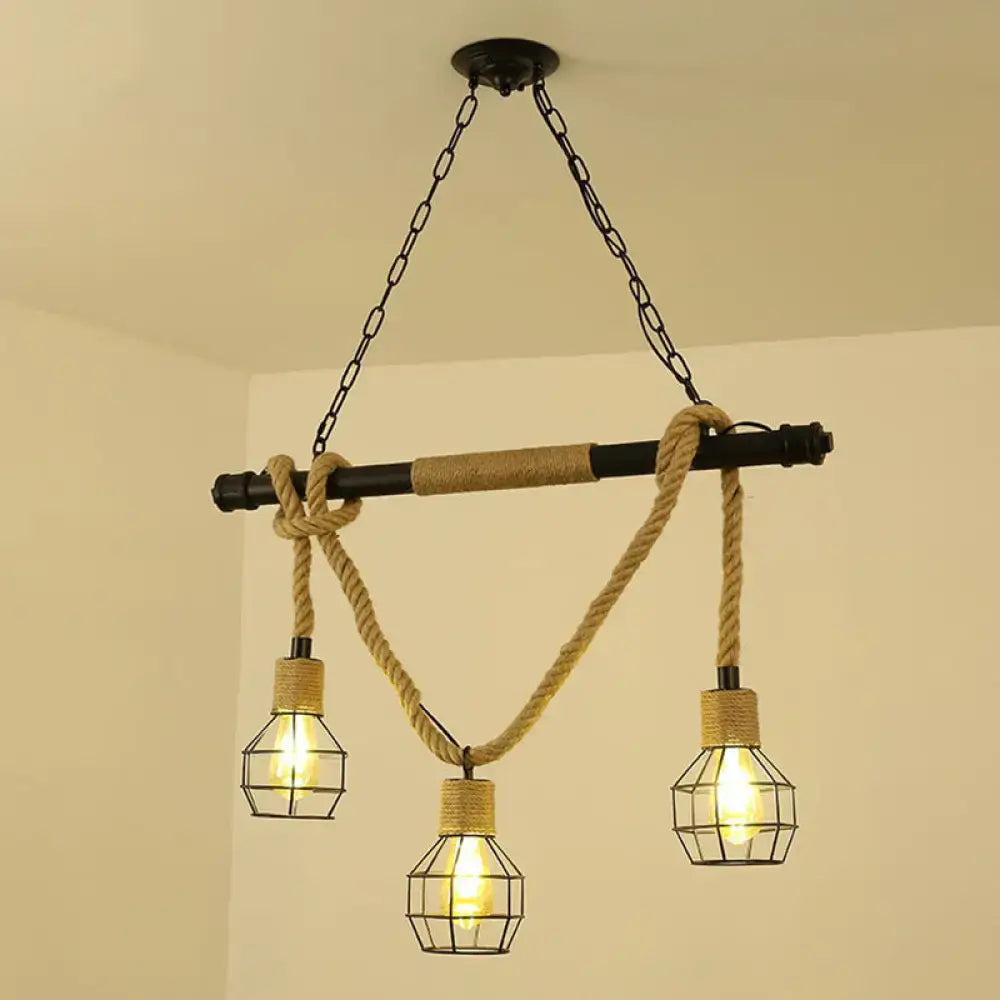 Decorbites™ antique iron hanging island light in black features industrial black pipe with three cage bulbs and hemp rope accents