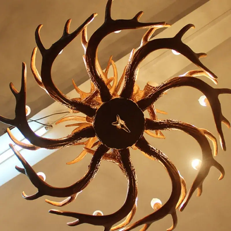 DecorBites antique resin antler chandelier with dark rustic finish and warm golden accents luxury vintage lighting fixture
