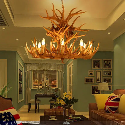Decorbites antique resin antler chandelier with warm golden brown finish and multiple lit bulbs for luxury vintage lighting