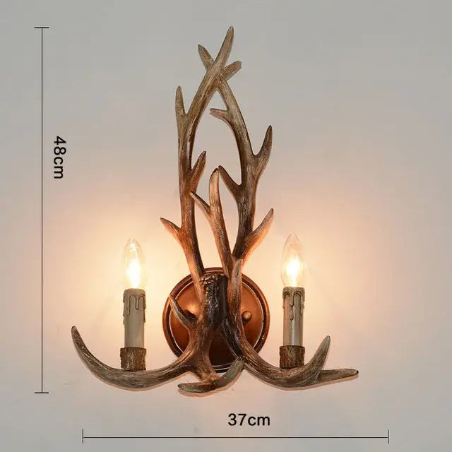 DecorBites antique resin antler wall sconce with two candle-style bulbs in rustic bronze finish for vintage lighting