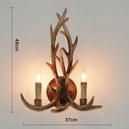 DecorBites antique resin antler wall sconce with two candle-style bulbs in rustic bronze finish for vintage lighting