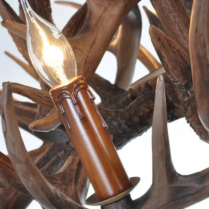 Candle-style bulb with warm glow in polished brown holder resembling wax drips on decorbites antique resin antler chandelier