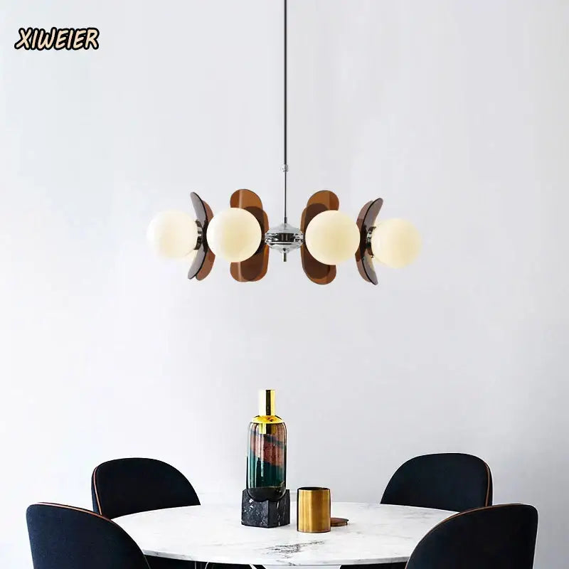 Modern pendant light featuring warm frosted glass globes and dark wood leaf accents in decorbites antique style chandelier