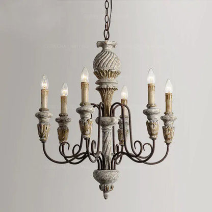 Decorbites antique white wooden chandelier with distressed gray and gold finish and ornate carved details