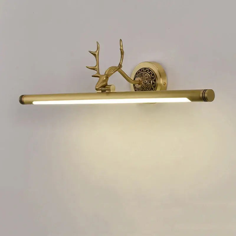 Gold-toned decorbites antler mirror light sconce with decorative stag head and ornate circular backplate for bedroom and bathroom