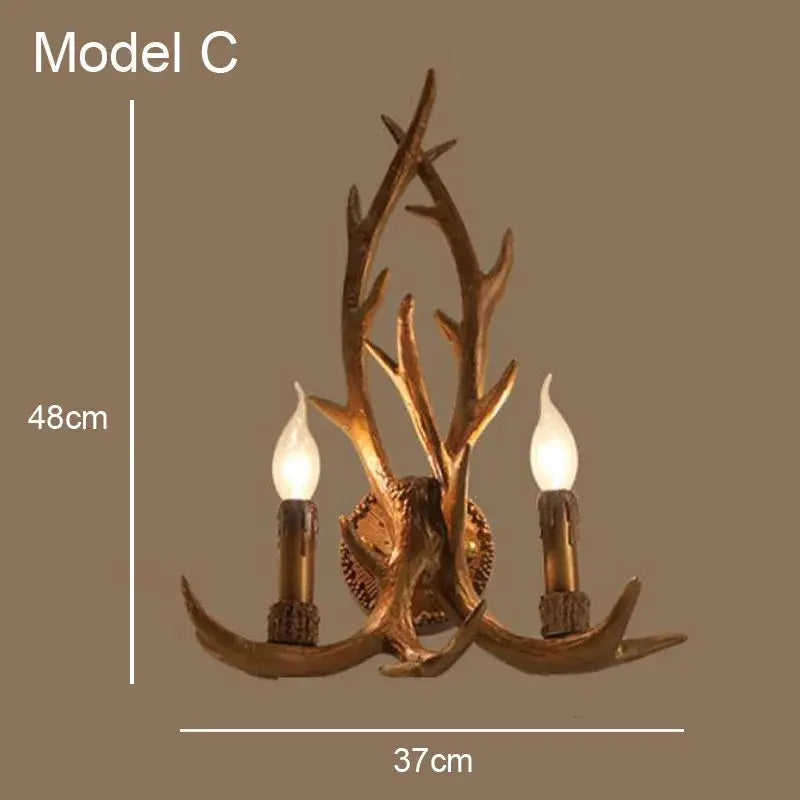 Decorbites antler chandelier featuring two candle-style bulbs in golden-brown resin for rustic indoor decor